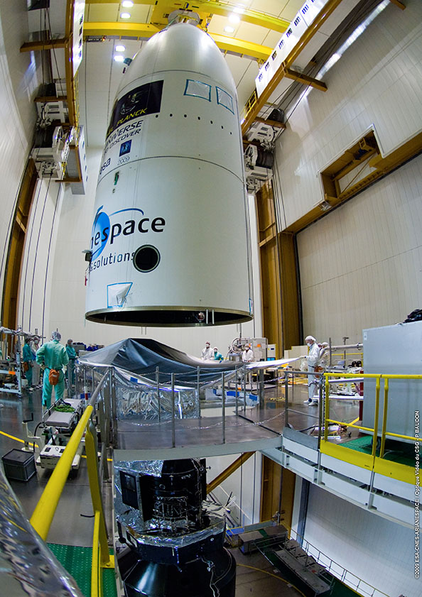 The fairing positioned above the spacecraft with the telescope still being covered The fairing positioned above the spacecraft with the telescope still being covered