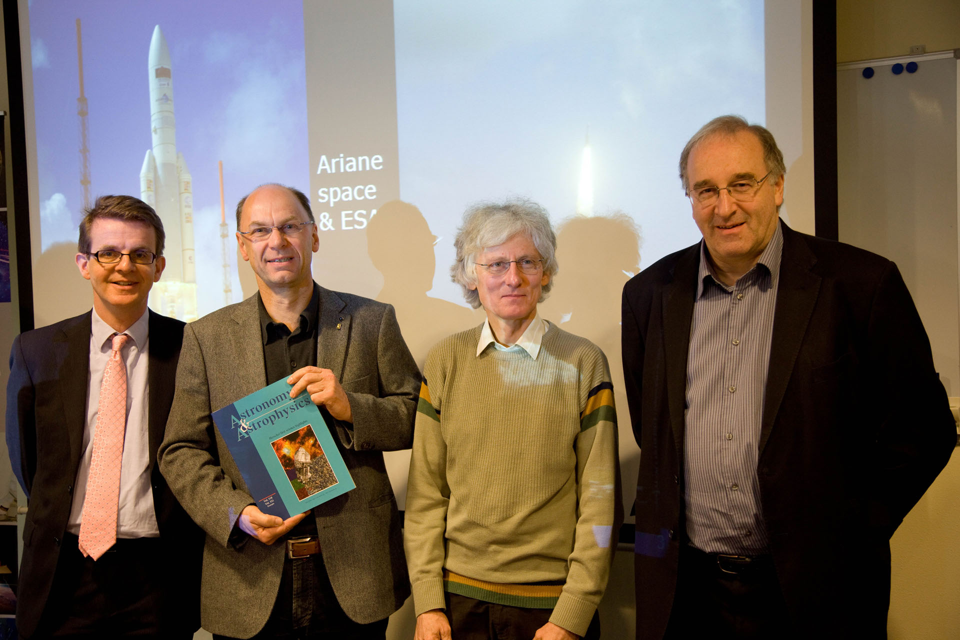 Frank Helmich, Göran Pilbratt, Albrecht Poglitsch, and Matt Griffin posing with one of the very first Herschel A&A special issue delivered to SRON Utrecht