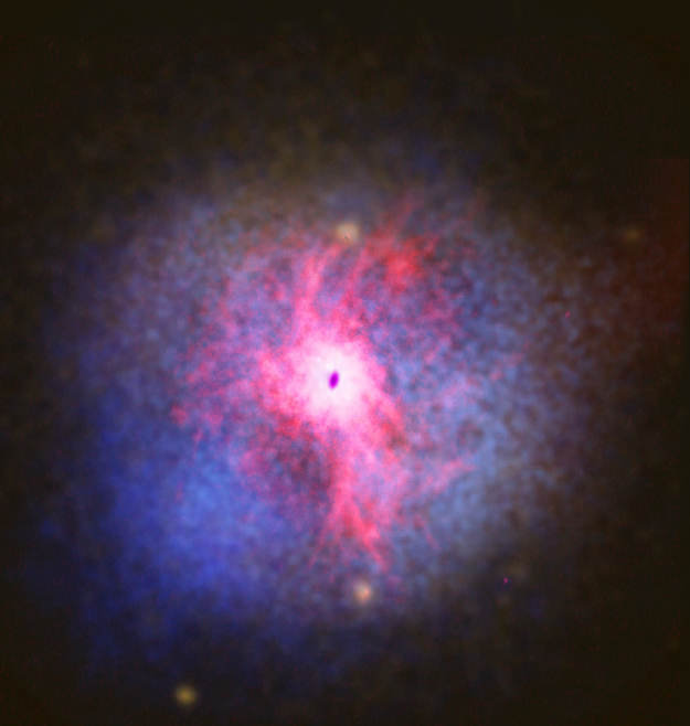 This image shows a composite view of the giant elliptical galaxy NGC 5044. Copyright: Digitised Sky Survey/NASA Chandra/Southern Observatory for Astrophysical Research/Very Large Array (Robert Dunn et al. 2010)