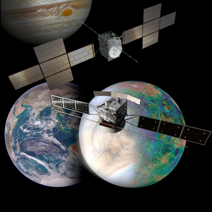 In the upper side, there is a model of JUICE spacecraft floating in front of Jupiter. Below, there is a model of the Envision spacecraft floating in front of two planets, Venus and Earth in the upper side of the image.