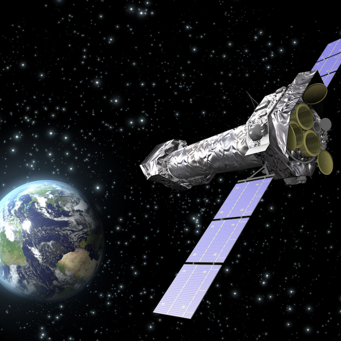 XMM-Newton is seen orbiting in space. The Earth is shown in the back